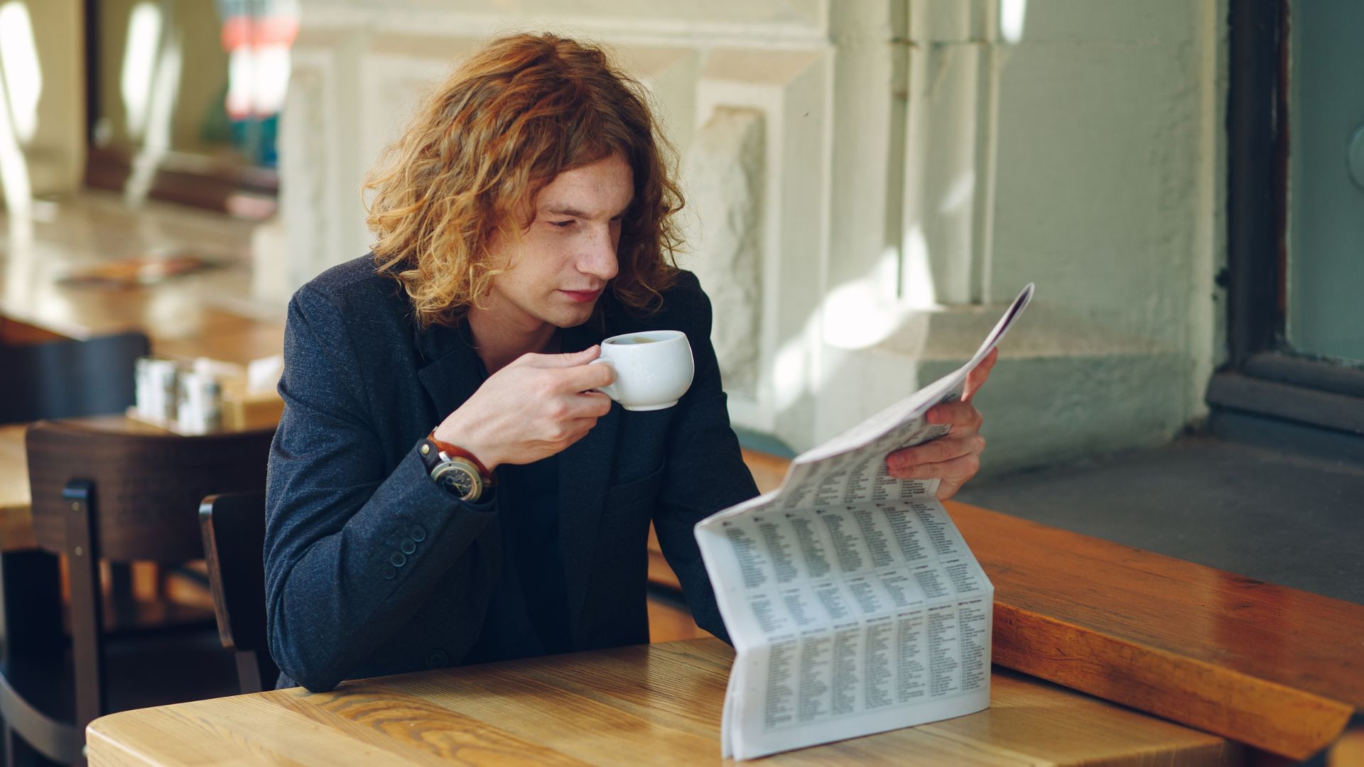 A man reading stock market prices.